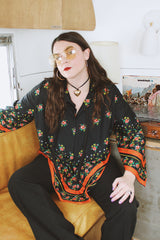 Women's vintage 1970's. Montgomery Ward label long sleeve black tunic blouse with a tie front neck and triangle shaped hem.