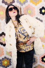 Women's vintage 1960's long sleeve genuine fur pea coat with a double breasted closure. Cream colored with all over brown speckles.