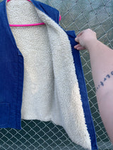 Men's or women's vintage 1970's sleeveless blue denim open front vest with cream shearling liner and pockets.