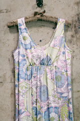 Women's vintage 1970's sleeveless ankle length maxi dress. Nightgown loungewear style with an all over pink, green, and blue pastel colored print.