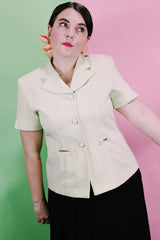 Women's vintage 1990's Sweet Suit label short sleeve button up blazer with double lapel and silver metal detail. In a light green and white all over checkered print.