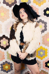 Women's vintage 1970's long sleeve genuine fur coat with double lapel in white with black and white patchwork details.