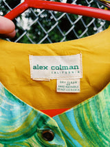 Women's vintage 1970's Alex Colman California label 3/4 arm length button up smock blouse in a vibrant green abstract print. Brass buttons and side slits.