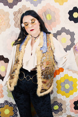 Women's vintage 1990's sleeveless vest with faux fur interior, a multicolored satin body, and faux fur trim.