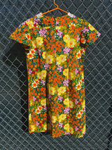 Women's vintage 1970's short sleeve mini length multicolored floral printed dress in polyester with lace trim collar.