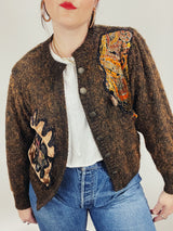 Women's vintage 1980's long sleeve brown orange wool cardigan with brass buttons and two abstract patches in the front.
