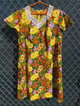 Women's vintage 1970's short sleeve mini length multicolored floral printed dress in polyester with lace trim collar.