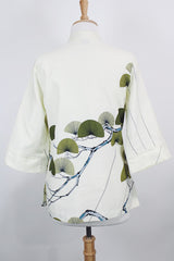 Women's vintage 1970's Tori Richard, Honolulu label cream colored long sleeve tunic blouse with floral print in the front and fabric buttons up the front.