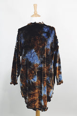 Long sleeve long length tie dye velvet top with a mock neck in a stretchy velvet material. Blue and brown colors with curly trim throughout.