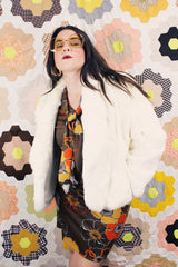 Women's vintage 1970's Wilsons Suede & Leather, Made in Korea label long sleeve bright white genuine fur coat with one hook and eye closure in the front.