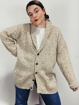 Men's vintage 1980's Rossan, Dongel Ireland, Hand Loomed in Ireland label long sleeve long length speckled cream colored button up cardigan with a rolled collar and brown buttons.