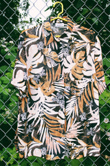 Women's vintage 1990's Glaser label short sleeve button up blouse with collar in a sheer material. All over black, white, and brown tropical flower print.