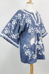 Women's vintage 1970's blue chambray tunic blouse with flared sleeves and a V shaped neckline. Has a white embroidered bird on the front.