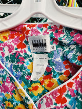 Women's vintage 1980's Leslie Fay matching set in an all over multicolored ditsy floral print. Short sleeve blazer jacket and midi pencil skirt.