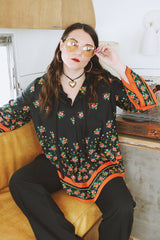 Women's vintage 1970's. Montgomery Ward label long sleeve black tunic blouse with a tie front neck and triangle shaped hem.