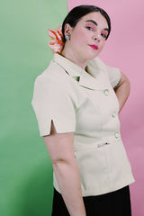 Women's vintage 1990's Sweet Suit label short sleeve button up blazer with double lapel and silver metal detail. In a light green and white all over checkered print.