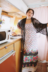 1970's vintage black lace triangle scarf with long fringe trim that can be worn as a shawl. Shop more vintage accessories at Live Forever Vintage.