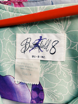 Women's vintage 1970's Butterfield 8, Made in USA label bell sleeved maxi length dress in light pastel green with Hawaiian floral print on the hem.