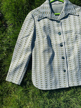 Women's vintage 1970's long sleeve button up shirt blouse in green and white printed polyester material.