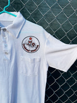 Women's or men's vintage 1970's short sleeve white polo t-shirt with half button closure and a graphic on the front left chest and one in the back.