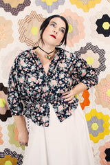 Women's vintage 1970's Ship N' Shore label short sleeve all over ditsy floral print blouse that buttons up the front and cinches at the waist.