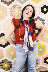 Women's vintage burnt orange acrylic crochet sweater top. Sleeveless with ruffles trim on shoulders. Has a short fit.