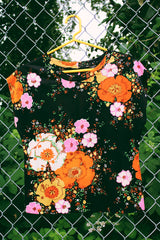 Women's vintage 1970's short capped sleeve top in black with pink and orange floral print all over. Sheer and lightweight.