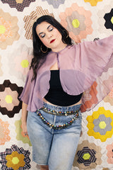 Women's vintage 1980's sheer silk material cape blouse in a light purple color. Has one hook and eye closure at neck with attached bow.