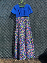 Women's vintage 1970's short sleeve maxi dress with a blue top and a multicolored printed skirt in polyester.