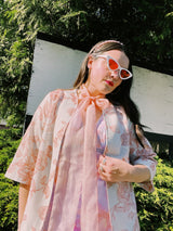 Women's vintage 1970's open front silver metallic blouse with short sleeves and all over white and pink rose floral print.