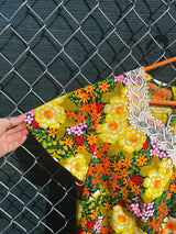 Women's vintage 1970's short sleeve mini length multicolored floral printed dress in polyester with lace trim collar.