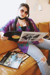 Women's vintage 1970's Cole of California label tie front blouse with balloon sleeves in purple, green, and orange colors and a lightweight polyester material.