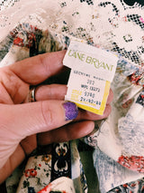 Women's vintage 1980's Lane Bryant label flutter sleeve blouse with cream lace trim and a square neckline. All over multicolored patchwork print.