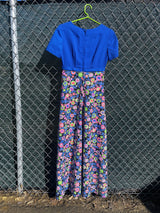 Women's vintage 1970's short sleeve maxi dress with a blue top and a multicolored printed skirt in polyester.