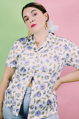 Women's vintage 1980's LORI by AM Casuals short sleeve button up blouse in white with all over blue floral print. Stretchy polyester material.