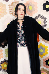 Women's vintage 1950's "365" by All-State label long sleeve knee length black velvet duster jacket with button front closure and pink satin liner.