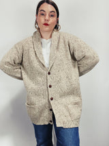 Men's vintage 1980's Rossan, Dongel Ireland, Hand Loomed in Ireland label long sleeve long length speckled cream colored button up cardigan with a rolled collar and brown buttons.