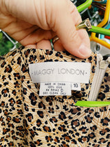 Women's vintage 1990's Maggy London label sleeveless midi length dress in an all over brown leopard print in a silk material. Wrap tie front detail.