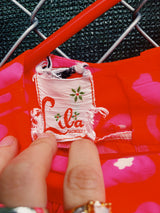 Women's vintage 1970's Liberty House for Lila Honolulu label sleeveless ankle length jumpsuit in a vibrant pink and orange Hawaiian print.