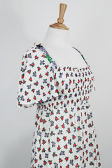 Women's vintage 1970's maxi length dress with flutter sleeves in white. Has an all over red and black ditsy floral print.
