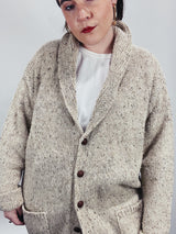 Men's vintage 1980's Rossan, Dongel Ireland, Hand Loomed in Ireland label long sleeve long length speckled cream colored button up cardigan with a rolled collar and brown buttons.