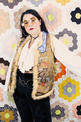 Women's vintage 1990's sleeveless vest with faux fur interior, a multicolored satin body, and faux fur trim.