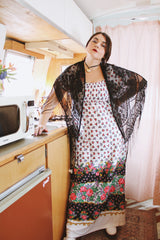 1970's vintage black lace triangle scarf with long fringe trim that can be worn as a shawl. Shop more vintage accessories at Live Forever Vintage.