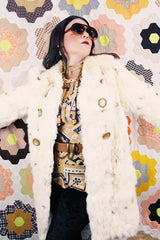 Women's vintage 1960's long sleeve genuine fur pea coat with a double breasted closure. Cream colored with all over brown speckles.