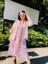 Women's vintage 1980's sleeveless midi length nightie dress in light purple, pink, and peach all over tie dye print. Has lace trim.