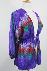 Women's vintage 1970's Cole of California label tie front blouse with balloon sleeves in purple, green, and orange colors and a lightweight polyester material.