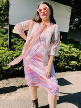 Women's vintage 1980's sleeveless midi length nightie dress in light purple, pink, and peach all over tie dye print. Has lace trim.