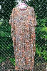 Women's vintage 1970's short sleeve maxi length muu muu kaftan dress in an all over leopard print in a polyester material.