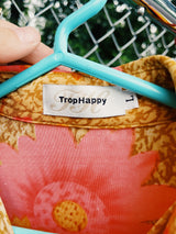 Women's vintage Y2k TropHappy label long sleeve top with collar and silver snap buttons up the front. Tan with all over bright pink flowers.