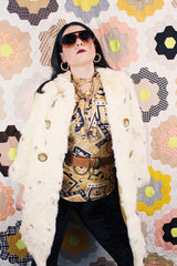 Women's vintage 1960's long sleeve genuine fur pea coat with a double breasted closure. Cream colored with all over brown speckles.